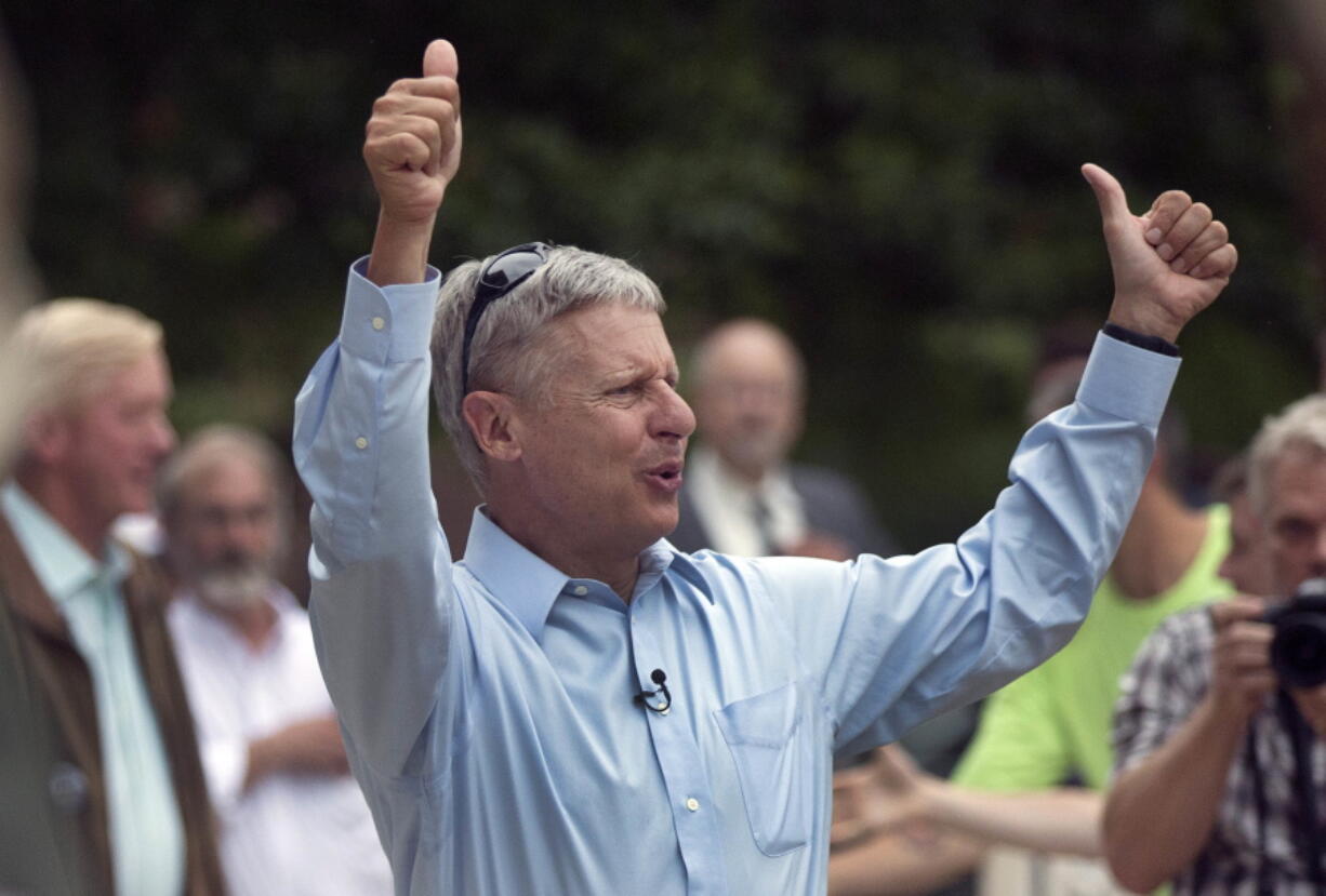 Former New Mexico governor, Libertarian presidential candidate Gary Johnson arrives to a cheering crowd of several hundred during a campaign rally Thursday in Concord, N.H.