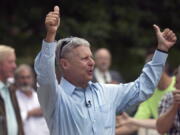 Former New Mexico governor, Libertarian presidential candidate Gary Johnson arrives to a cheering crowd of several hundred during a campaign rally Thursday in Concord, N.H.