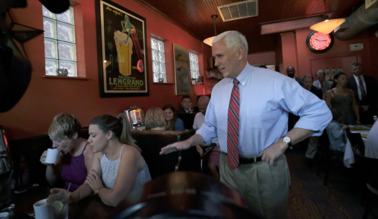 Republican vice presidential candidate, Indiana Gov. Mike Pence, right, surprises patrons at Millie&#039;s Diner in Richmond, Va. Saturday, Aug. 27, 2016, during an impromptu visit by the candidate to the popular restaurant.