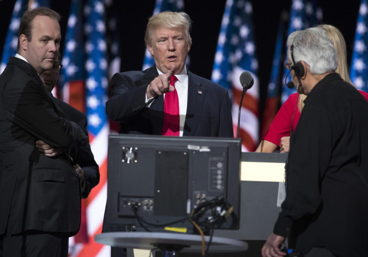 Republican presidential candidate Donald Trump, center, accompanied by Trump campaign aide Rick Gates, left, prepares for his speech at the Republican National Convention in Cleveland.