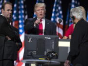 Republican presidential candidate Donald Trump, center, accompanied by Trump campaign aide Rick Gates, left, prepares for his speech at the Republican National Convention in Cleveland.