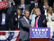 Republican presidential candidate Donald Trump welcomes Nigel Farage, ex-leader of the British UKIP party, to speak at a campaign rally in Jackson, Miss., on Wednesday.