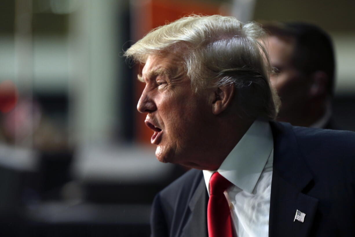 Republican presidential candidate Donald Trump calls out to supporters as he exits after speaking in Charlotte, N.C. Trump is on the clock.