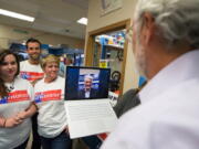 U.S. Congressional District 4 candidate Rep. Dan Newhouse, right, talks with candidate for governor Bill Bryant, center, over Skype at Sharky&#039;s Pizza Shack in Yakima on Tuesday.