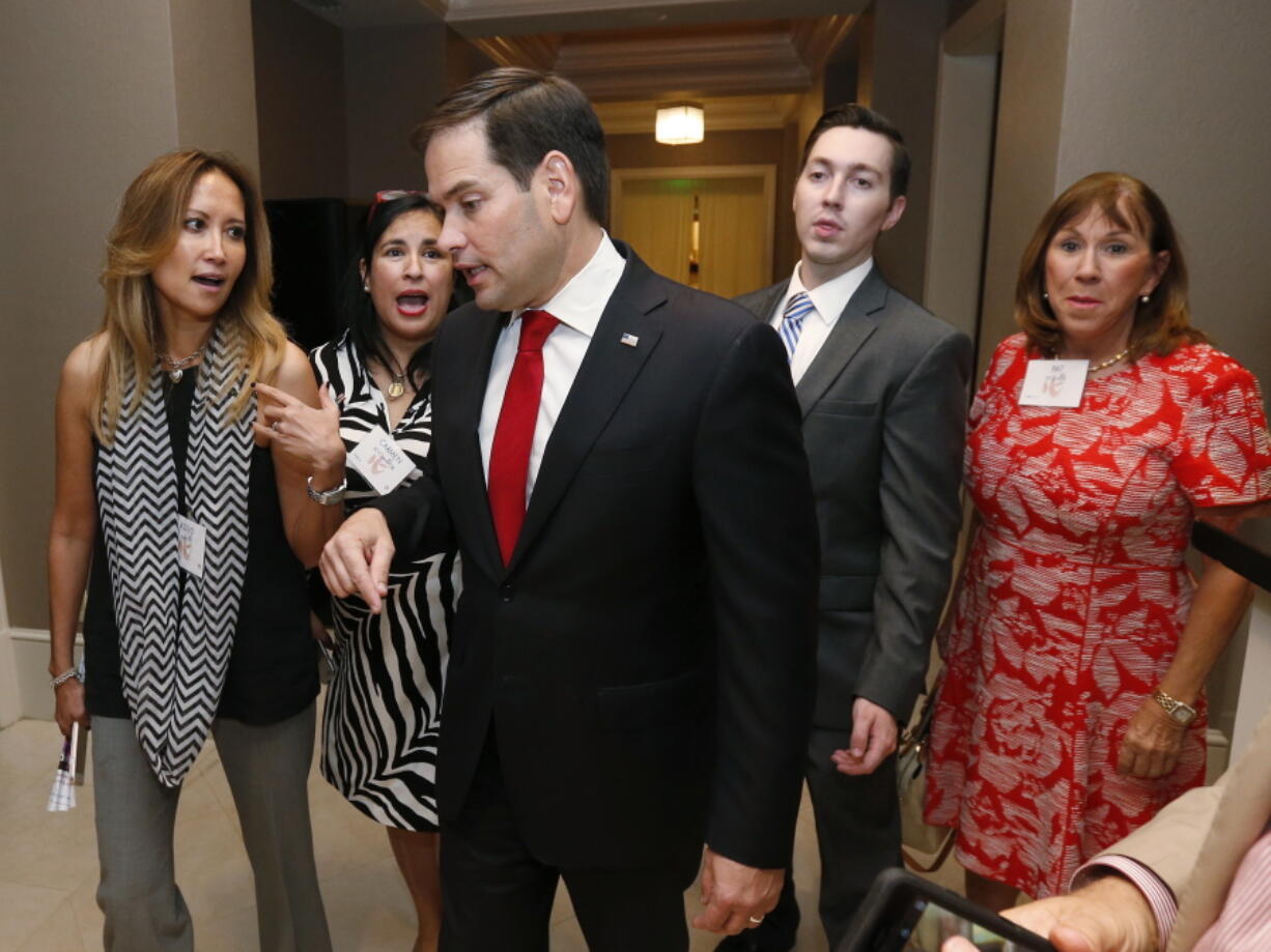 Sen. Marco Rubio, R-Fla., center, chats with attendees as he prepares to speak at the Republican Party of Palm Beach County&#039;s 15th annual Lobsterfest in Boca Raton, Fla.