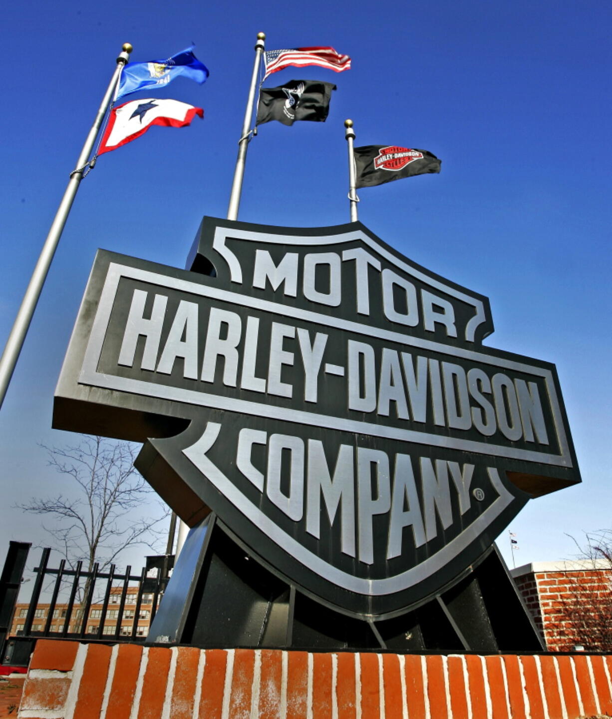 A sign stands outside the corporate offices of Harley Davidson in Milwaukee. Harley-Davidson has agreed to pay $15 million to settle a complaint filed by federal environmental officials over racing tuners that caused its motorcycles to emit higher than allowed levels of air pollution.