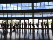 People line up March 31, 2014, to enroll for health insurance at the Alamodome in San Antonio, Texas, hours before the deadline in the first enrollment period of the Affordable Care Act.