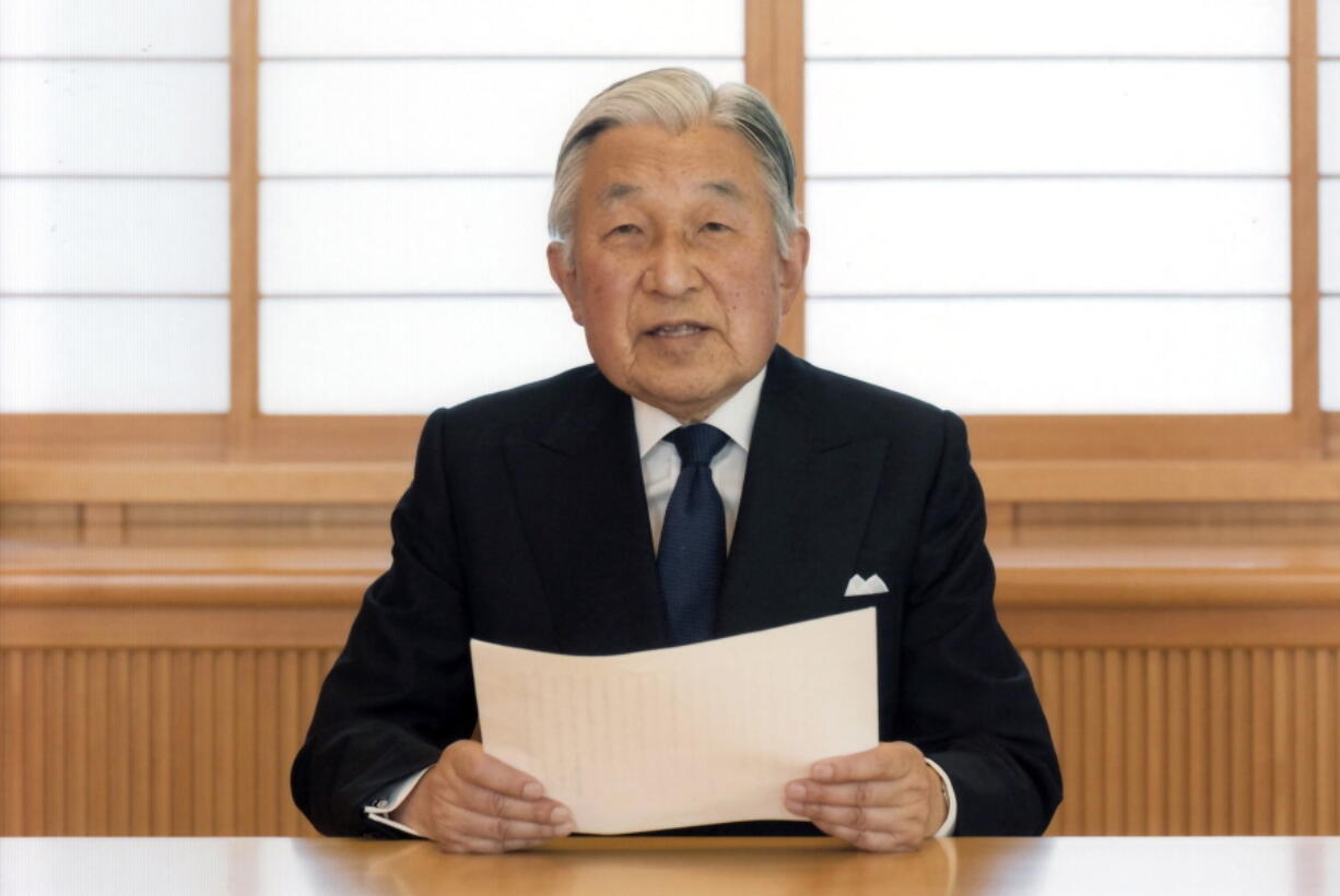 Japan&#039;s Emperor Akihito reads a message for recording at the Imperial Palace in Tokyo.