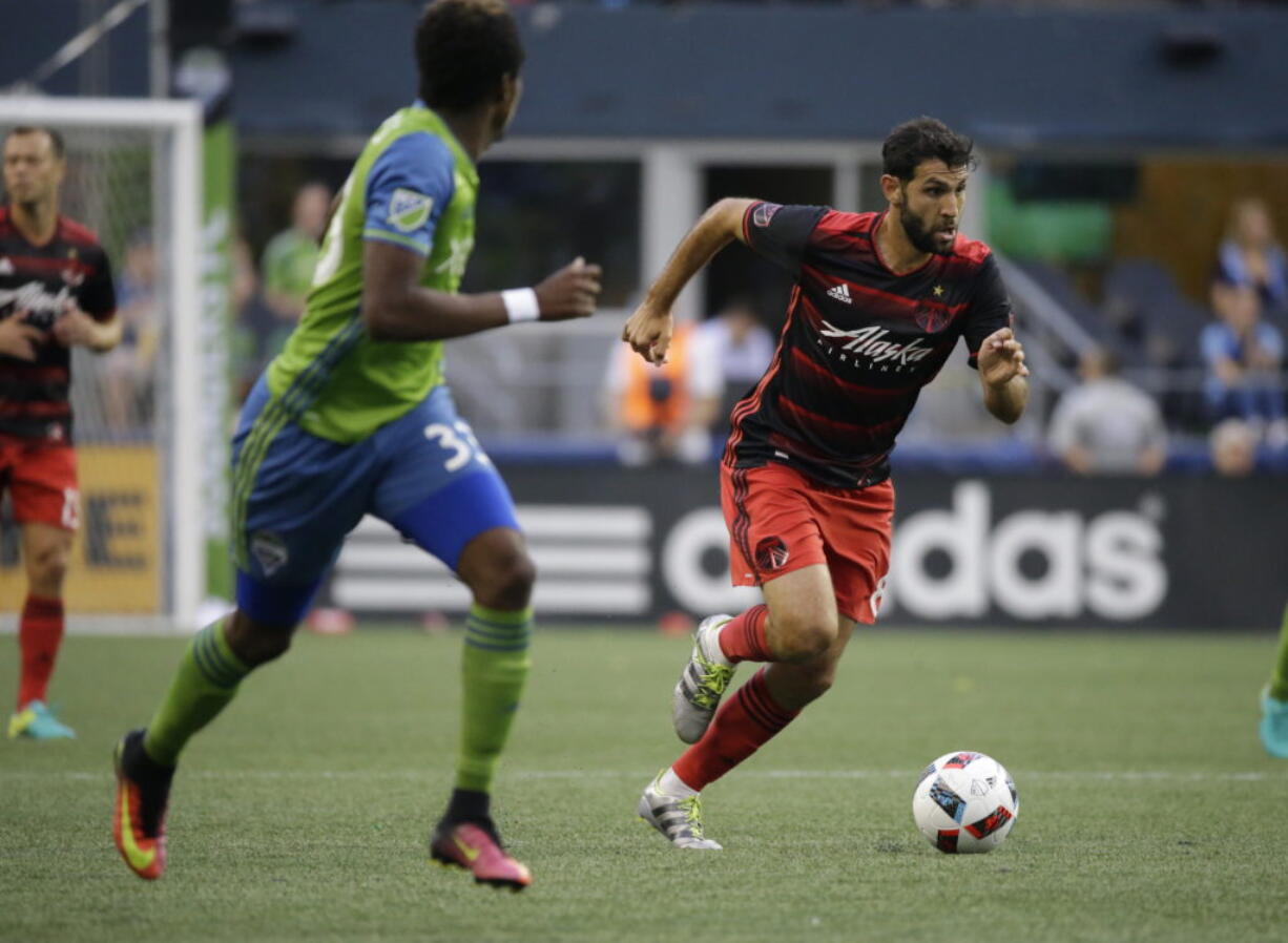 Portland Timbers midfielder Diego Valeri, right, moves the ball past Seattle Sounders defender Joevin Jones, left, in the first half of an MLS soccer match, Sunday, Aug. 21, 2016, in Seattle. (AP Photo/Ted S.