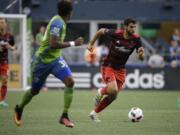 Portland Timbers midfielder Diego Valeri, right, moves the ball past Seattle Sounders defender Joevin Jones, left, in the first half of an MLS soccer match, Sunday, Aug. 21, 2016, in Seattle. (AP Photo/Ted S.