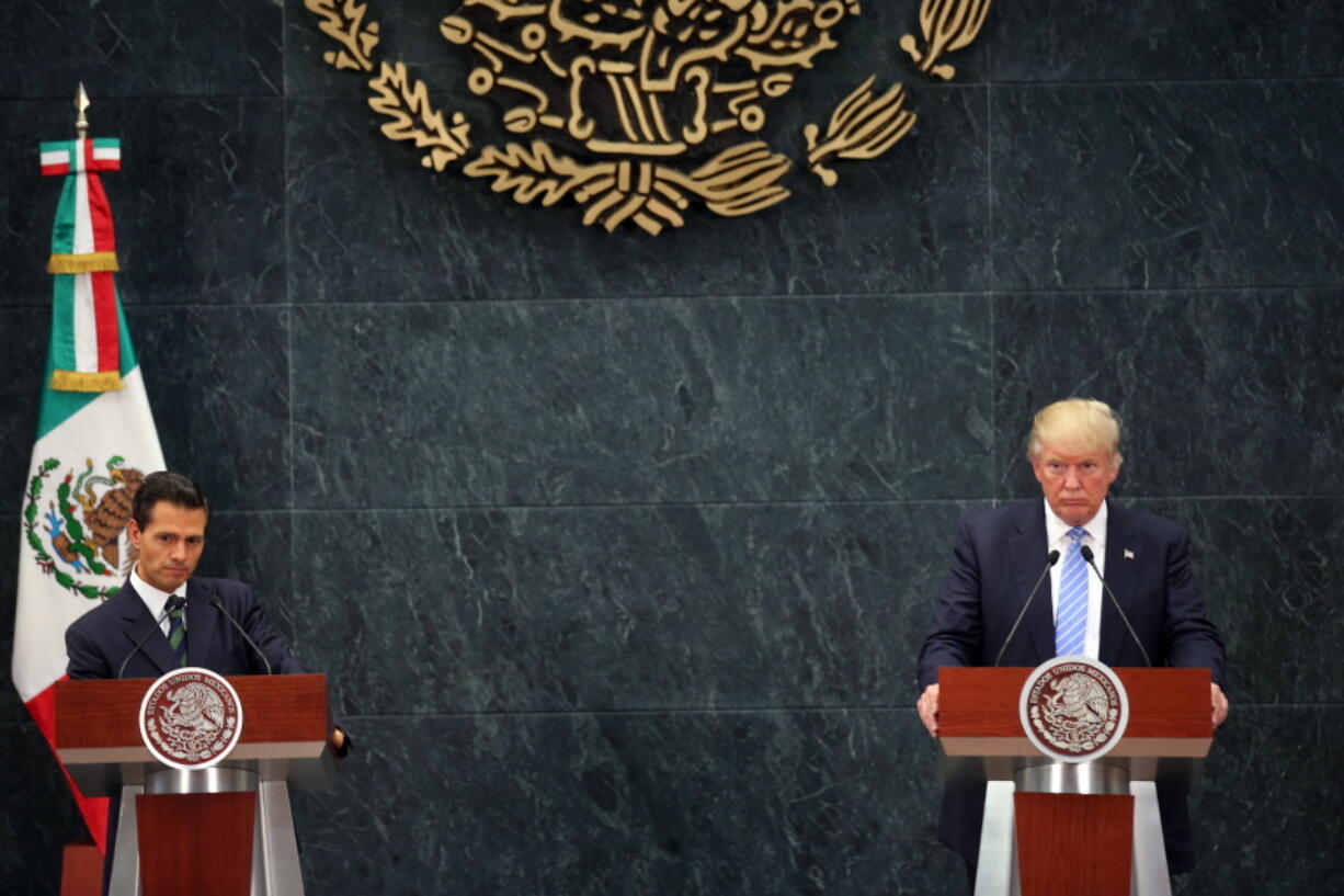 Republican presidential candidate Donald Trump, right, and Mexico&#039;s President Enrique Pena Nieto, listen to a reporter&#039;s question during a joint statement Wednesday at Los Pinos, the presidential official residence in Mexico City.