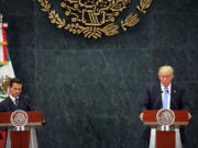 Republican presidential candidate Donald Trump, right, and Mexico&#039;s President Enrique Pena Nieto, listen to a reporter&#039;s question during a joint statement Wednesday at Los Pinos, the presidential official residence in Mexico City.