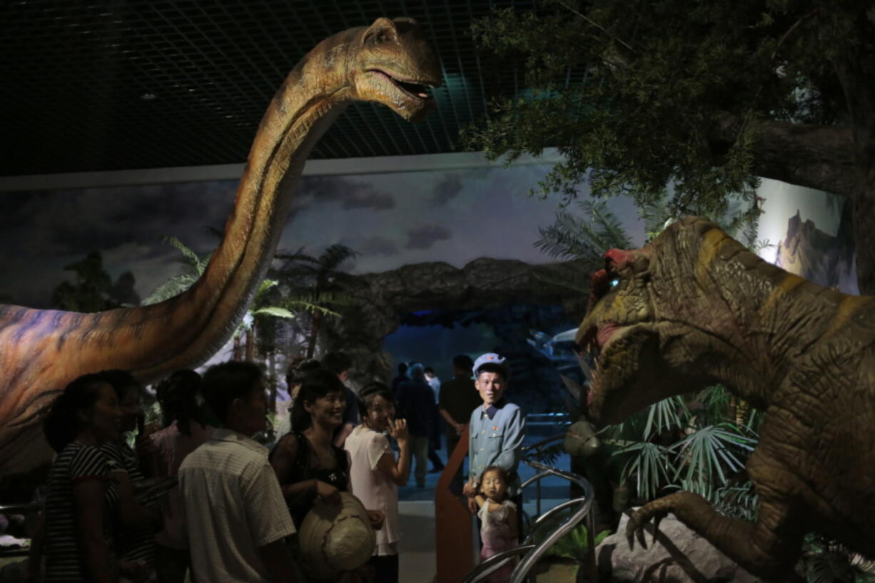 North Koreans look at models of dinosaurs at the Natural History Museum, part of the newly opened Pyongyang Central Zoo in Pyongyang, North Korea, on Tuesday. North Korean leader Kim Jong Un&#039;s latest gift to the lucky residents of Pyongyang, the renovated central zoo, is pulling in thousands of visitors a day with a slew of attractions ranging from such typical zoo fare as elephants, giraffes, penguins and monkeys to a high-tech natural history museum.