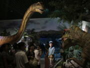 North Koreans look at models of dinosaurs at the Natural History Museum, part of the newly opened Pyongyang Central Zoo in Pyongyang, North Korea, on Tuesday. North Korean leader Kim Jong Un&#039;s latest gift to the lucky residents of Pyongyang, the renovated central zoo, is pulling in thousands of visitors a day with a slew of attractions ranging from such typical zoo fare as elephants, giraffes, penguins and monkeys to a high-tech natural history museum.