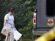 A Mississippi Bureau of Investigation agent takes a bag with evidence from the Durant, Miss., home of two slain Catholic nuns who worked as nurses at the Lexington Medical Clinic, to her vehicle, Thursday. (AP Photo/Rogelio V.