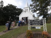 People stand in line to attend a vigil for the deceased held at St. Thomas Catholic Church in Lexington, Miss., for Sister Margaret Held and Sister Paula Merrill on Sunday. The two nuns, from different orders, were found murdered in the Durant, Miss., house they rented, on Thursday. Over 300 people attended the service. Although authorities have arrested a suspect, they speculate on the motive of the deaths of the two nurse practitioners, who worked the poor in a clinic in Lexington. (AP Photo/Rogelio V.