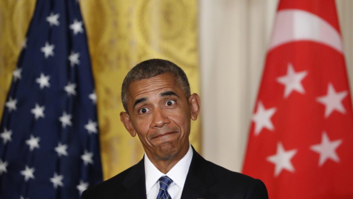 President Barack Obama reacts to questions asked by members of the media during a joint news conference with Singapore&#039;s Prime Minister Lee Hsien Loong in the East Room of the White House in Washington on Tuesday.