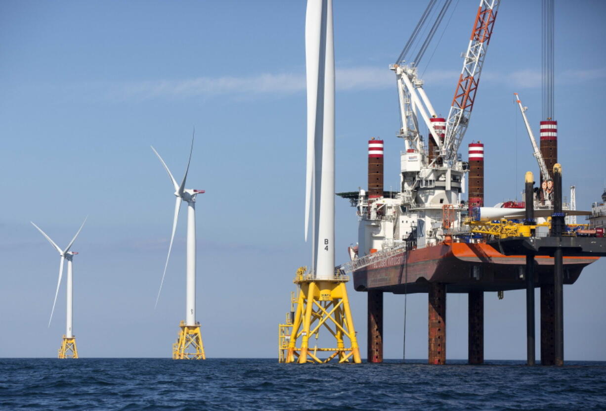 A lift boat, right, that serves as a work platform, assembles a wind turbine off Block Island, R.I., Monday, Aug. 15, 2016. Deepwater Wind&#039;s $300 million five-turbine wind farm off Block Island is expected to be operational this fall.