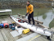 ADVANCE FOR RELEASE SATURDAY, AUG. 6, 2016 AND THEREAFTER In this July 25, 2016 photo, Austin Jones unpacks his foldable kayak in Juneau, Alaska, after finishing a trip from Anacortes, Washington, to Juneau. Jones&#039; &quot;origami kayak,&quot; as the manufacturer&#039;s website puts it, looks like it&#039;s made out of corrugated cardboard, something more suited to campaign signs than open seas.