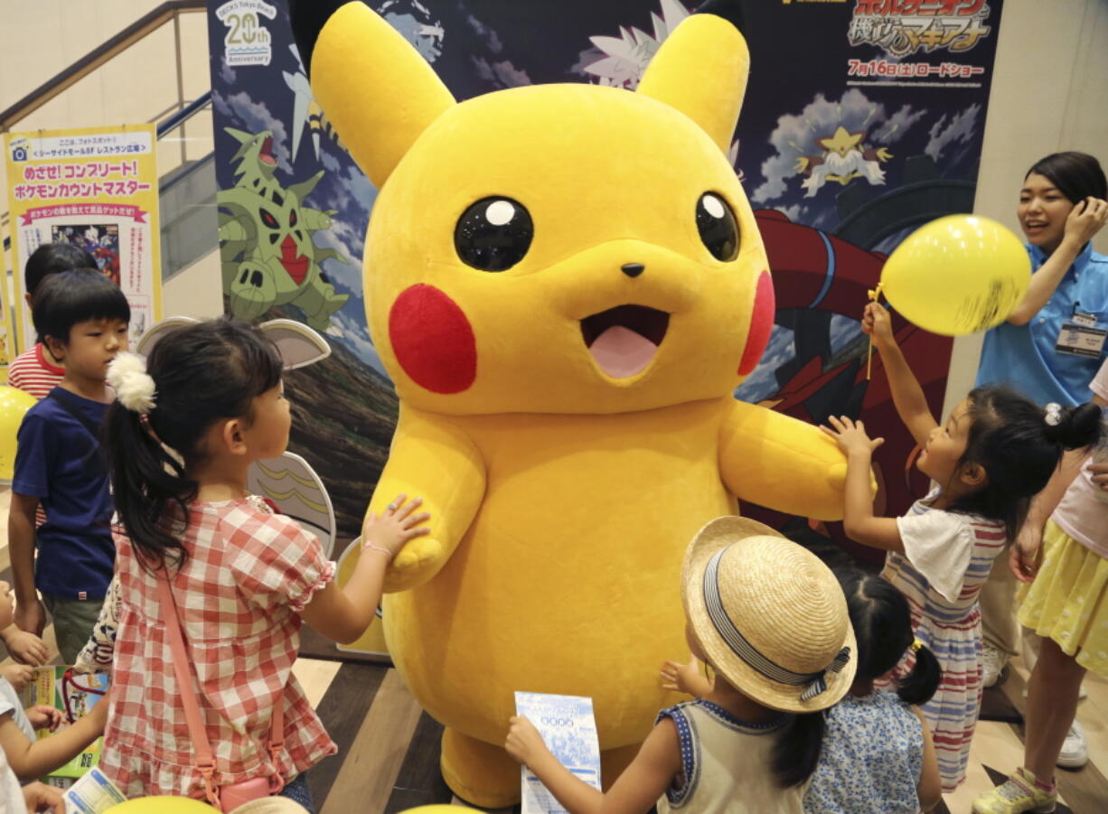 A stuffed toy of Pikachu, a Pokemon character, is surrounded by children during a Pokemon festival in Tokyo. A real-life Pikachu statue appeared in a New Orleans park. New Orleans police told ABC News for a story published August 2, 2016, that they have no plans to remove it.