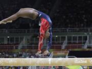 United States' Simone Biles performs on the balance beam during the artistic gymnastics women's qualification at the 2016 Summer Olympics in Rio de Janeiro, Brazil, Sunday, Aug. 7, 2016.