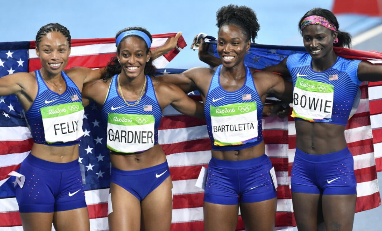 The United States team from left, Allyson Felix, English Gardner, Tianna Bartoletta and Tori Bowie celebrate winning the gold medal in the women&#039;s 4x100-meter relay final during the athletics competitions of the 2016 Summer Olympics at the Olympic stadium in Rio de Janeiro, Brazil, Friday, Aug. 19, 2016.