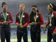 The United States women&#039;s 4x400 meter relay team members, Courtney Okolo, Natasha Hastings, Phyllis Francis and Allyson Felix stand on the podium with their gold medals during athletics competitions at the Summer Olympics inside Olympic stadium in Rio de Janeiro, Brazil, Saturday, Aug. 20, 2016. (AP Photo/Jae C.