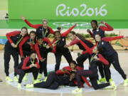 United States team members pose for a photo after the gold medal basketball game against Spain at the 2016 Summer Olympics in Rio de Janeiro, Brazil, Saturday, Aug. 20, 2016.