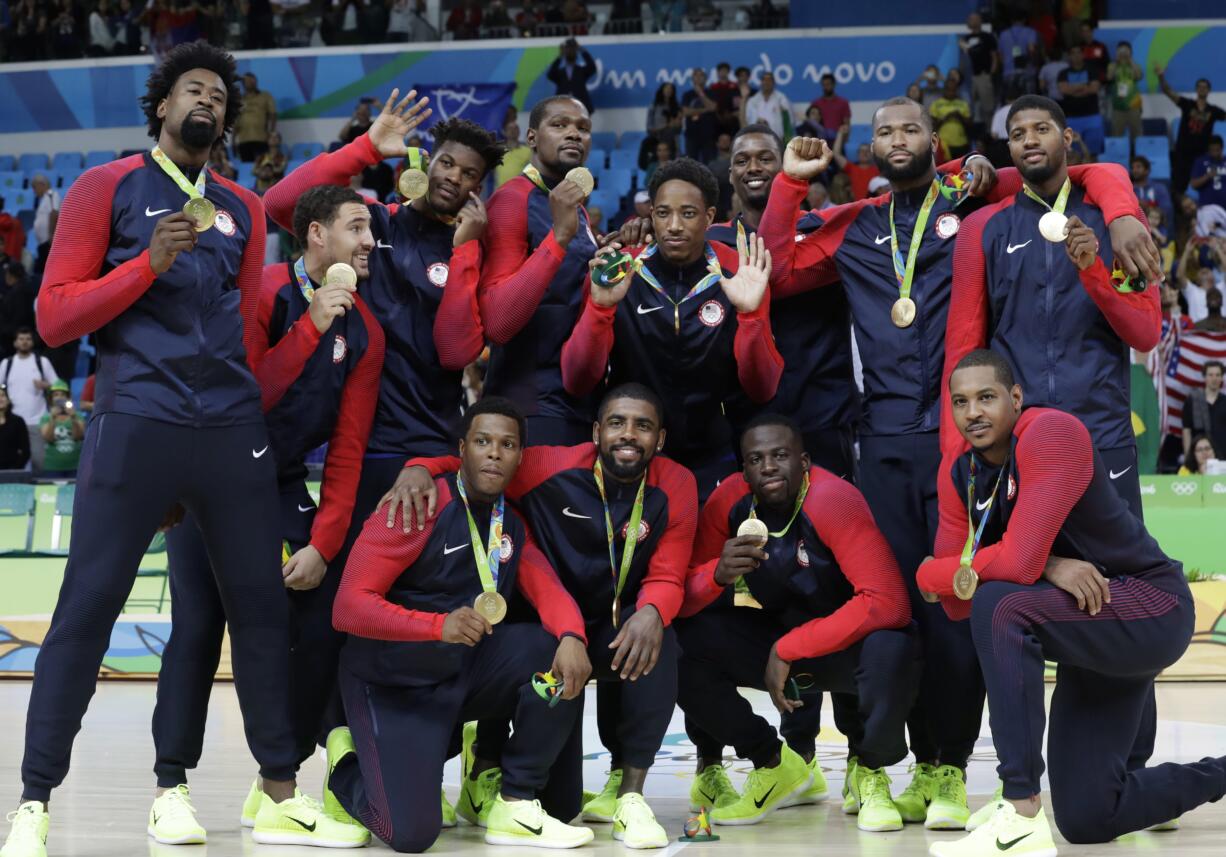 The United States' team pose with their gold medals for men's basketball at the 2016 Summer Olympics in Rio de Janeiro, Brazil, Sunday, Aug. 21, 2016.