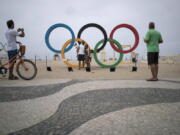 People take photos by the Olympic rings decorating Copabana Beach in Rio de Janeiro, Brazil. In the city&#039;s 2009 Olympic bid document, authorities pledged the games would &#039;regenerate Rio&#039;s magnificent waterways.&#039; A promised billion-dollar investment in cleanup programs was meant to be among the games&#039; most important legacies, but once more, the lofty promises have ended in failure.