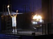 Brazilian marathoner Vanderlei de Lima lights the Olympic flame during the opening ceremony for the 2016 Summer Olympics in Rio de Janeiro, Brazil, Friday, Aug. 5, 2016.