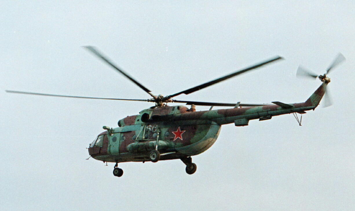 A Mi-8 helicopter flies over the Chechen regional capital Grozny, Russia. A helicopter similar to the one pictured has been shot down in Syria and Russian President Vladimir Putin&#039;s spokesman says all people aboard it have been killed, Monday, Aug. 1, 2016.