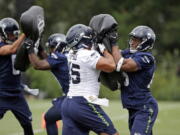 Seattle Seahawks&#039; Brandon Williams, right, and Taani Tupou run through a drill during the team&#039;s NFL football training camp Saturday, July 30, 2016, in Renton, Wash.