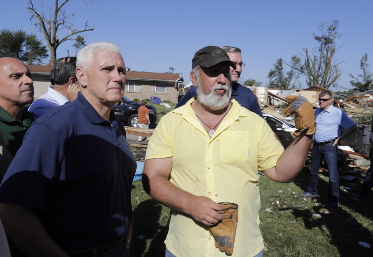 Republican vice presidential candidate, Indiana Gov. Mike Pence talks with Terry Munson, Thursday, Aug. 25, 2016, in Kokomo, Ind. Munson&#039;s home was hit by a tornado that passed through the area Wednesday afternoon.