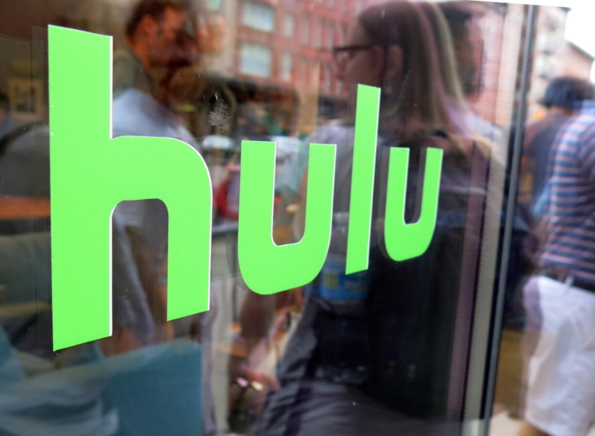 The Hulu logo is shown on a window at the Milk Studios space in New York on June 26, 2015.  Time Warner is taking a 10 percent stake in streaming television service Hulu, announced Wednesday, Aug. 3, 2016.  In addition, networks such as TNT, TBS, CNN and Cartoon Network will be available live and on-demand on the live-streaming service that Hulu is expected to launch next year.