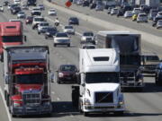 Truck and automobile traffic mix on Interstate 5, headed north through Fife  near the Port of Tacoma.  (AP Photo/Ted S.