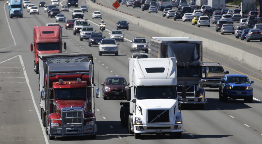 Truck and automobile traffic mix on Interstate 5, headed north through Fife  near the Port of Tacoma.  (AP Photo/Ted S.