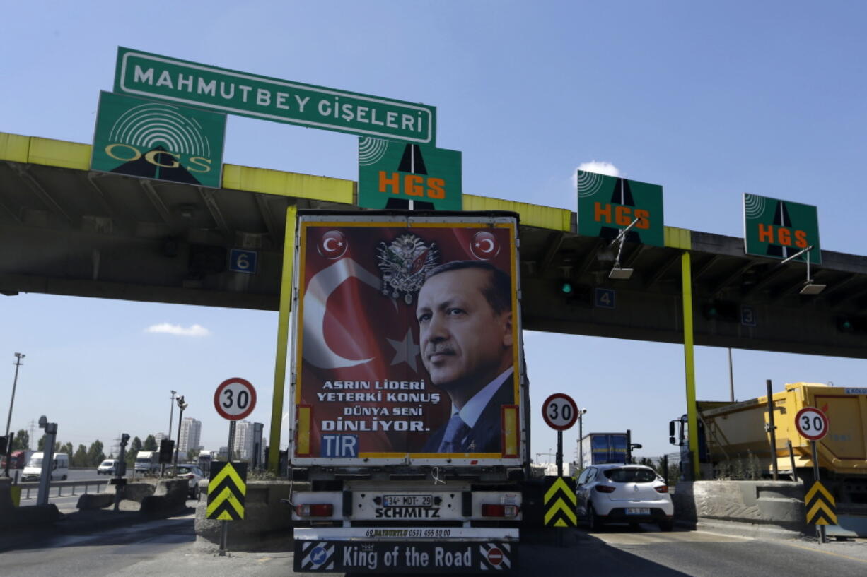 The back of a truck carries a poster portrait of Turkish President Recep Tayyip Erdogan and reading &quot;The leader of this century may you speak, the whole world listening to you,&quot; passes the highway toll station in Istanbul, on Wednesday. Turkey issued a decree Wednesday for the conditional release of some 38,000 low level prisoners, Justice Minister Bekir Bozdag said Wednesday, in a move being seen as reducing its prison population to make space for thousands of people arrested following last month&#039;s failed coup.