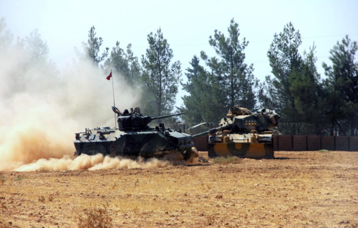 A Turkish army tank and an armored vehicle are stationed near the border with Syria, in Karkamis, Turkey, Tuesday, Aug. 23, 2016. Turkish media reports say Turkish artillery on Tuesday launched new strikes at Islamic State targets across the border in Syria, after two mortar rounds, believed to have been fired by the militants, hit the town of Karkamis, in Turkey&#039;s Gaziantep province.