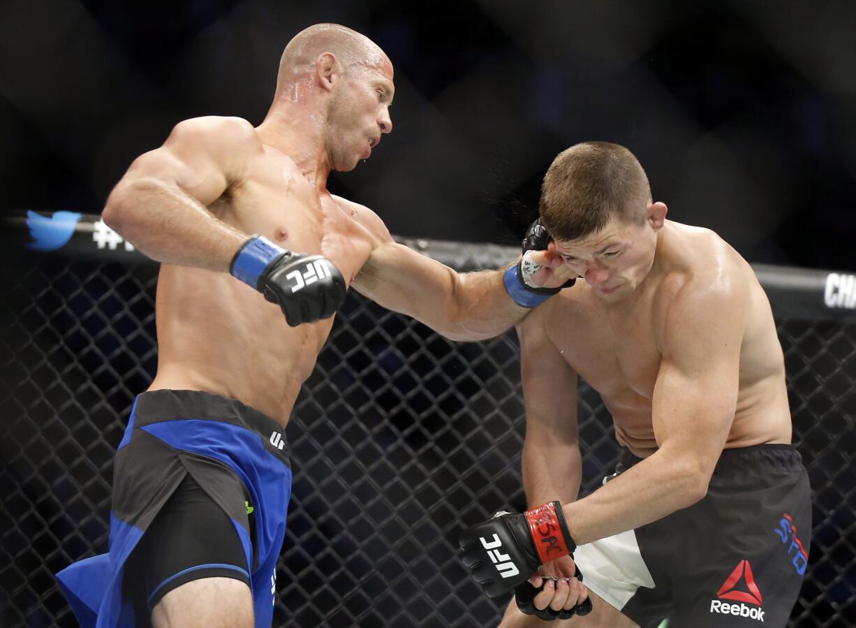 Donald Cerrone, left, punches Rick Story, a resident of Vancouver, during their welterweight mixed martial arts bout at UFC 202 on Saturday, Aug. 20, 2016, in Las Vegas. Corrine won the bout.