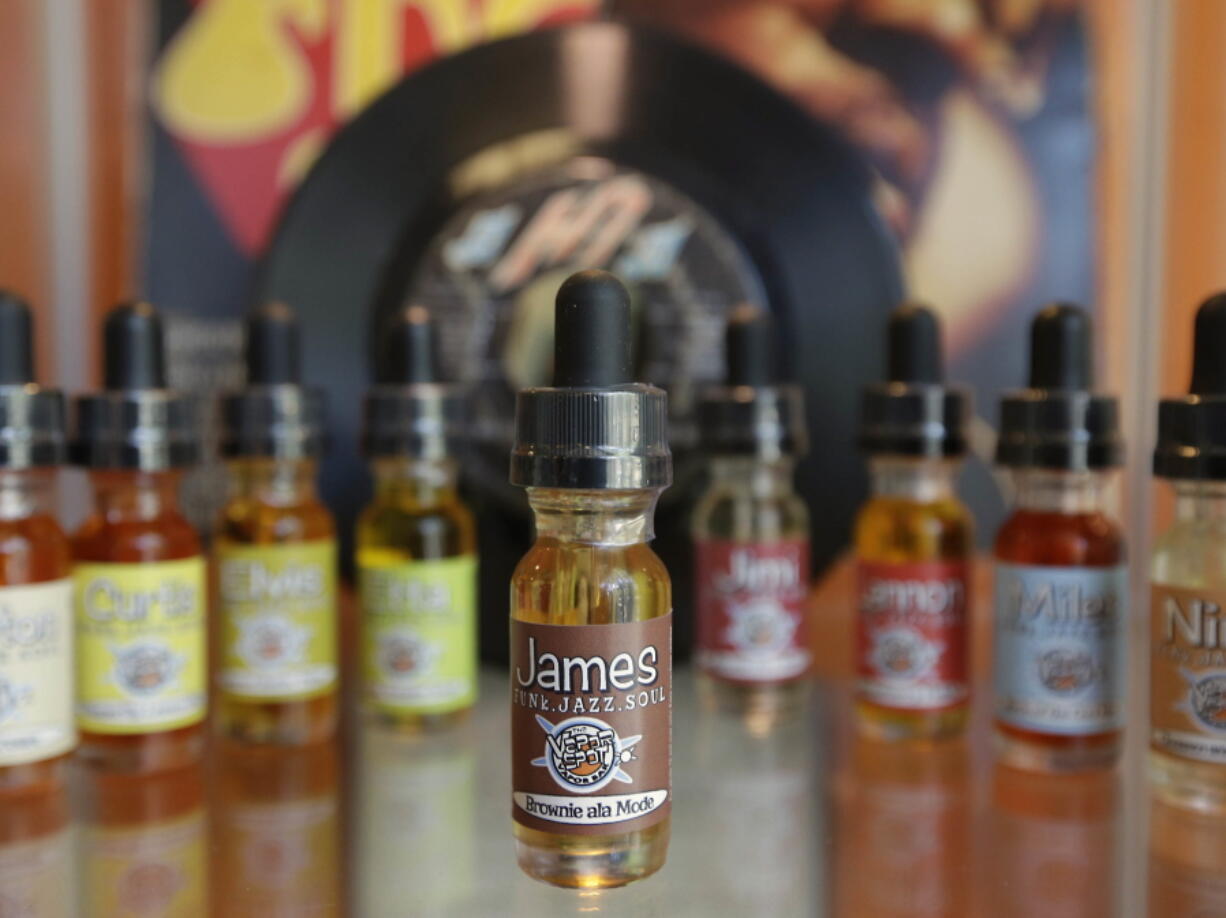 Bottles of various flavors of vapor solution, known as &quot;e-juice,&quot; for use in e-cigarettes and vaping tools such as tanks at a shop in Sacramento, Calif.