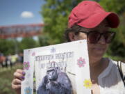 Alesia Buttrey, of Cincinnati, holds a sign with a picture of the gorilla Harambe during a May vigil in his honor outside the Cincinnati Zoo &amp; Botanical Garden, in Cincinnati.