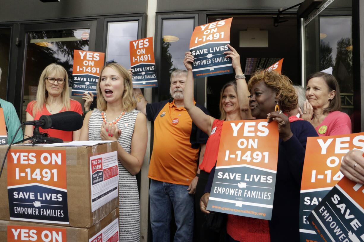 Stephanie Ervin, campaign manager for Yes on I-1491, speaks to the media in Olympia in July about the turning in of more than 330,000 signatures in support of a ballot measure on gun access. I-1491 would create protection orders that could take guns away from a person deemed a serious threat to themselves or others.