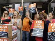 Stephanie Ervin, campaign manager for Yes on I-1491, speaks to the media in Olympia in July about the turning in of more than 330,000 signatures in support of a ballot measure on gun access. I-1491 would create protection orders that could take guns away from a person deemed a serious threat to themselves or others.