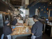 Master baker Melissa Ayers, left, prepares dough for pizza with sous chef Cameron Winchester, center, and chef-owner Alan Maniscalco on Tuesday afternoon at Rally Pizza.