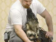 Mitchell Baldwin gets a kiss from Oliver, a 22-month-old Guardian Angels Medical Service dog.