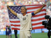 United States&#039; Abby Wambach holds up the U.S. flag as she celebrates after the U.S. beat Japan 5-2 in the FIFA Women&#039;s World Cup soccer championship in Vancouver, British Columbia, Canada, Sunday, July 5, 2015.