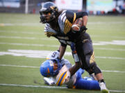 Hudson&#039;s Bay running back Marco Cadiz runs over a would-be tackler during a game against Rochester.