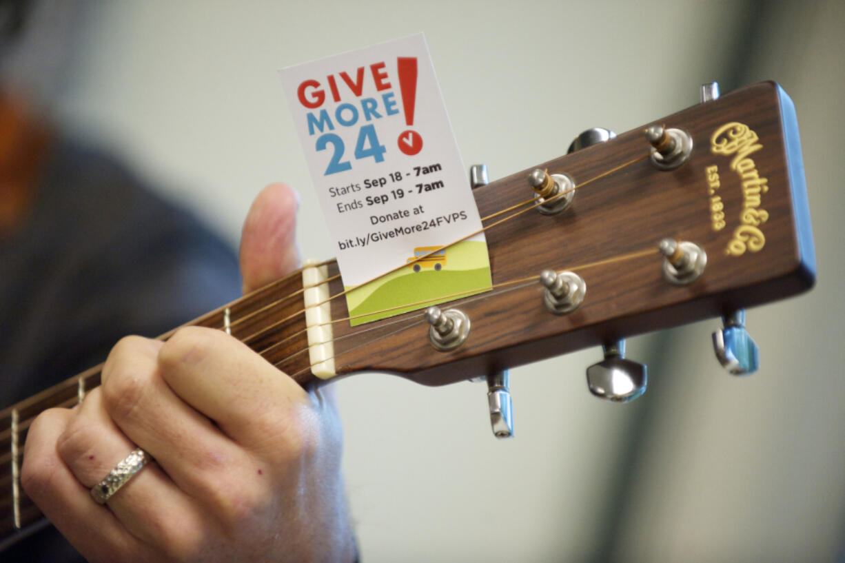 Pat Kearns of the band Blue Skies for Black Hearts plays a few songs for the staff at MacKay Sposito as part of 2014&#039;s Give More 24! charity event. This year&#039;s 24-hour event is scheduled for Thursday.