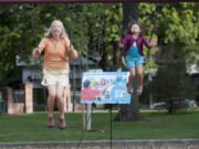 Jane Van Dyke, left, takes part in Give More 24! by participating in marathon swinging as Maxine Born-Bullock swings nearby in Vancouver in 2015 as part of the annual 24-hour online giving competition, in which nonprofits encourage giving throughout the day with parties and promotions.